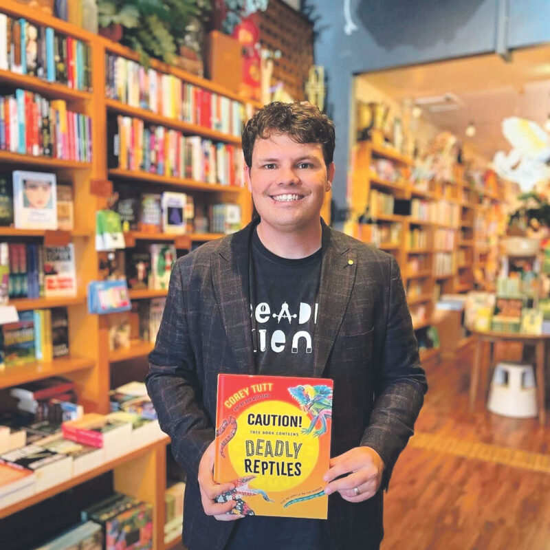 Corey Tutt OAM with his book, Caution! This Book Contains Deadly Reptiles.