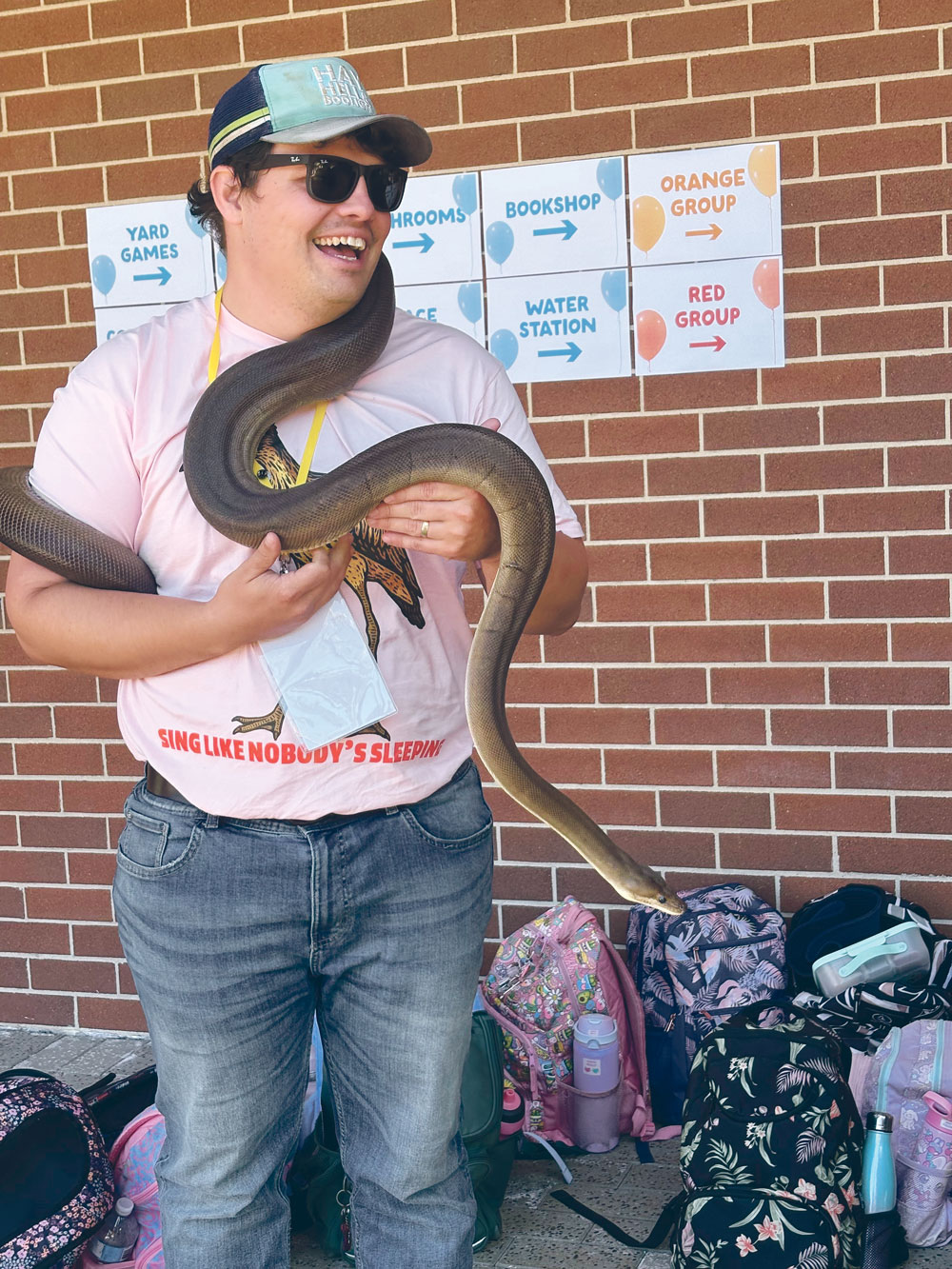 Corey with a snake during a DeadlyScience school visit.