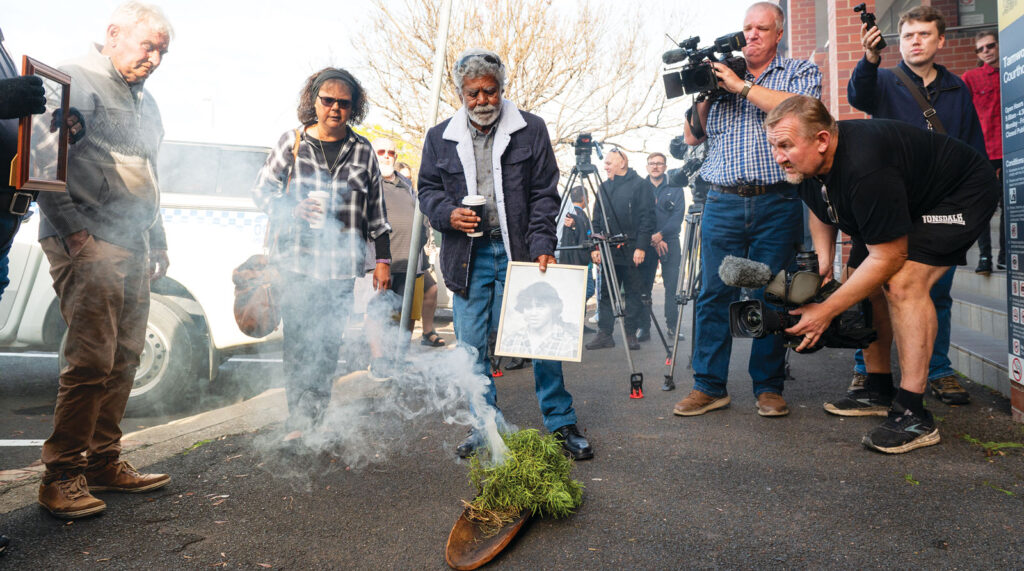 Mark Haines’ sister Lorna and Uncle Don ‘Duck’ Craigie (centre) during a traditional smoking ceremony outside Tamworth courthouse, on June 18. Mark Haines, 17, died from a traumatic head injury on January 16, 1988. His body was found near train tracks about 8km south of Tamworth. Picture: AAP.