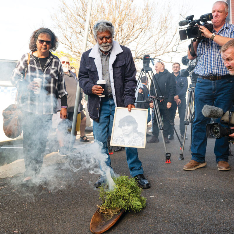 Mark Haines’ sister Lorna and Uncle Don ‘Duck’ Craigie (centre) during a traditional smoking ceremony outside Tamworth courthouse, on June 18. Mark Haines, 17, died from a traumatic head injury on January 16, 1988. His body was found near train tracks about 8km south of Tamworth. Picture: AAP.